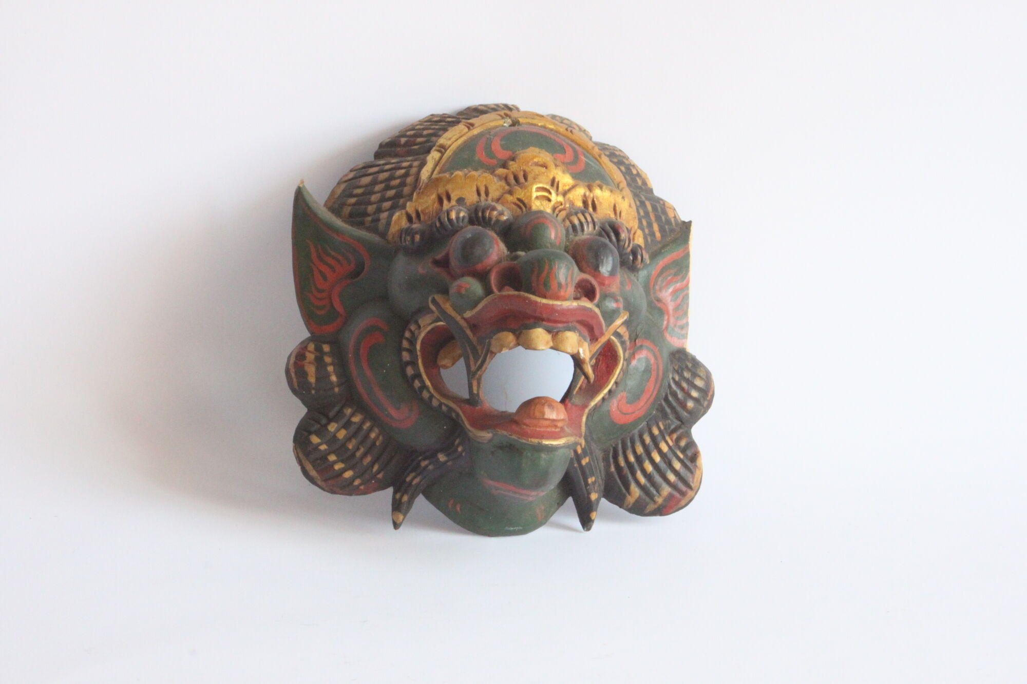 Two polychrome painted and gold leaf gilded Barong dance masks from Bali, Indonesia.
