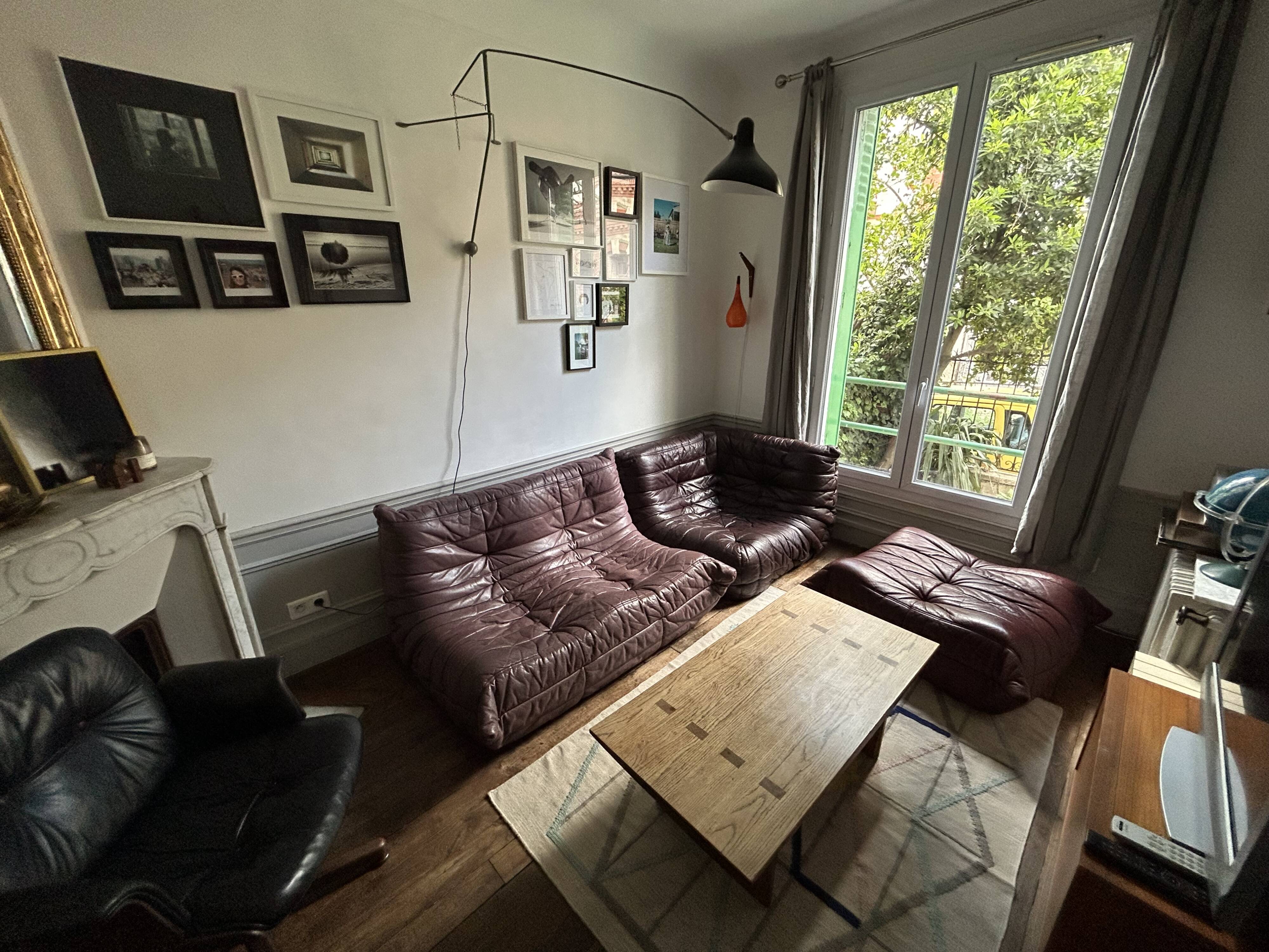 Togo set by Ligne Roset in vintage pink, plum, and burgundy leather.