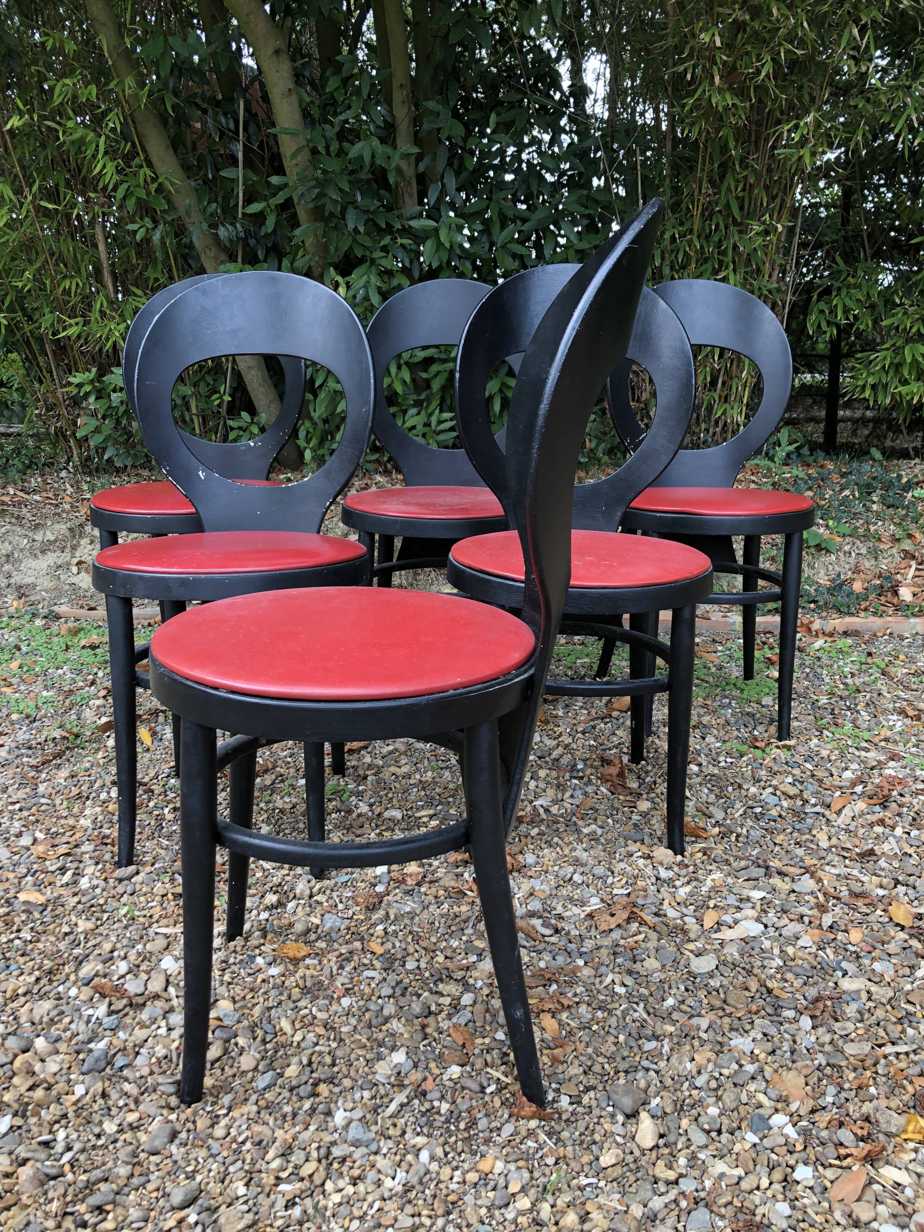 6 vintage Baumann seagull model chairs, black lacquered with red Skai seats.