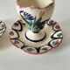 Pair of HB Quimper egg cups with integrated pedestal base, floral decoration