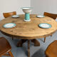 Round table in solid wood, thick top, vintage brutalist style from the 1960s.