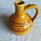 Round ochre glazed jug with handle