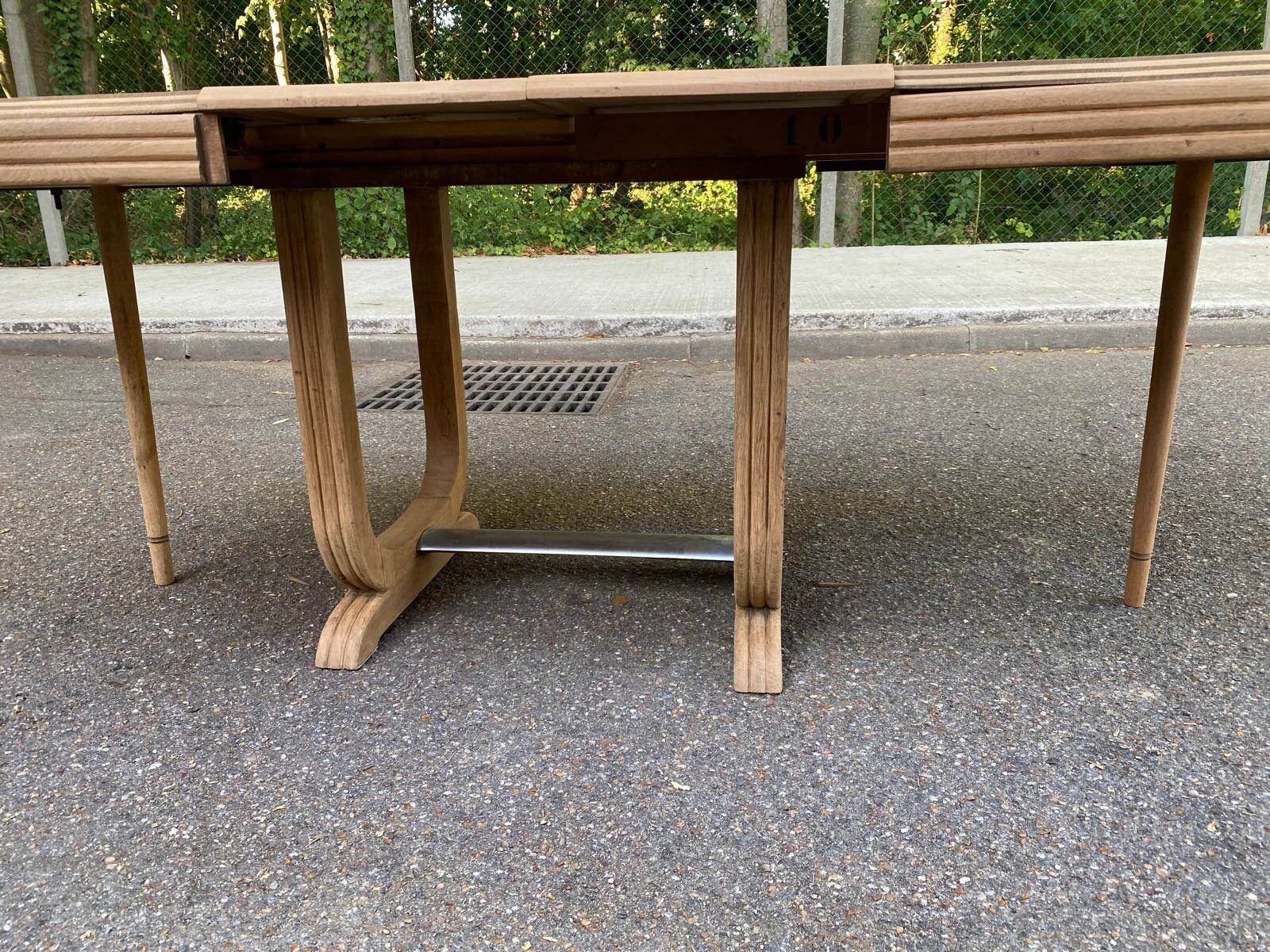 Art Deco dining table with a central pedestal, stripped in solid oak, with 2 extensions.