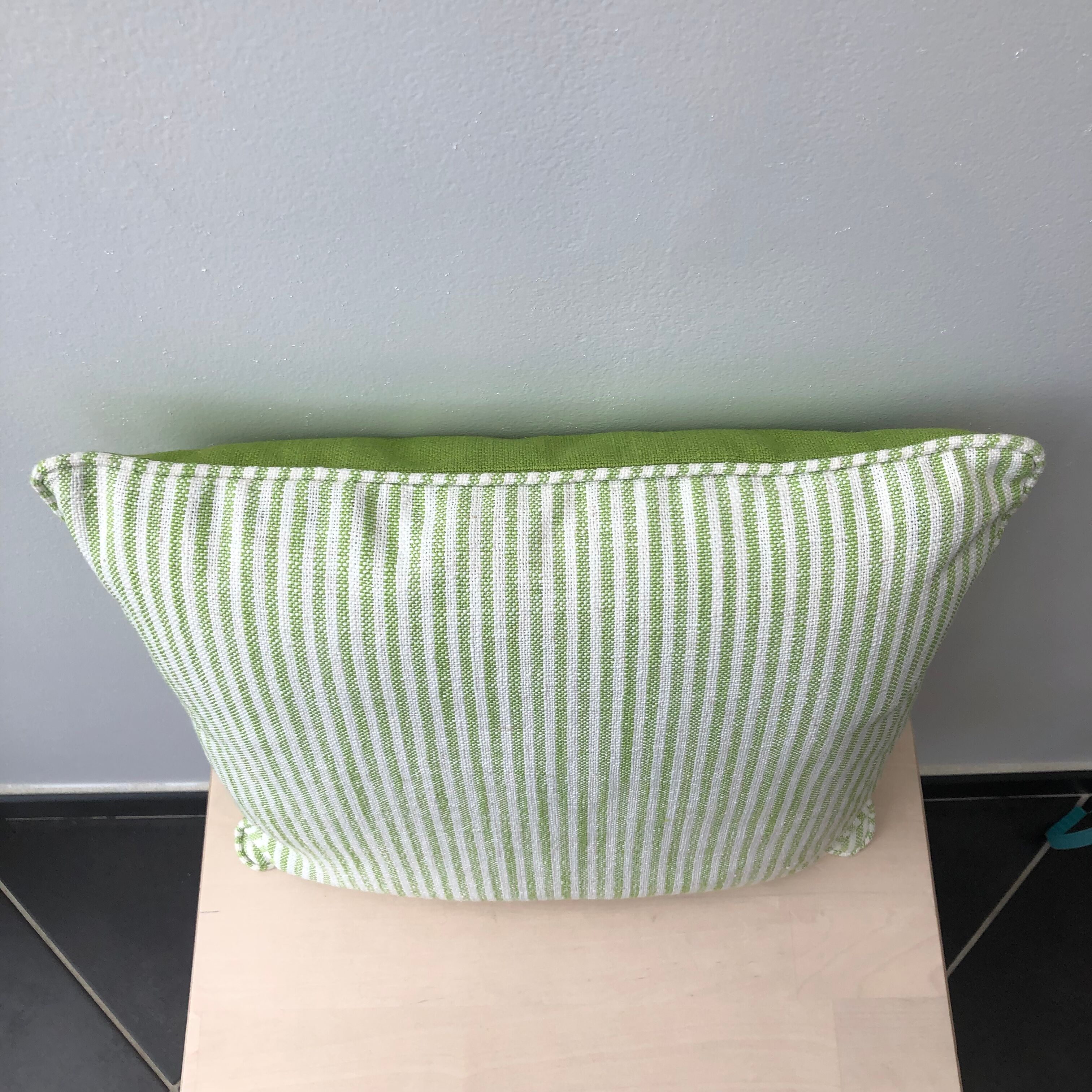 Green and white striped cushion