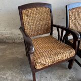 Set of two colonial dark-brown wooden armchairs with natural rattan seating (pair)