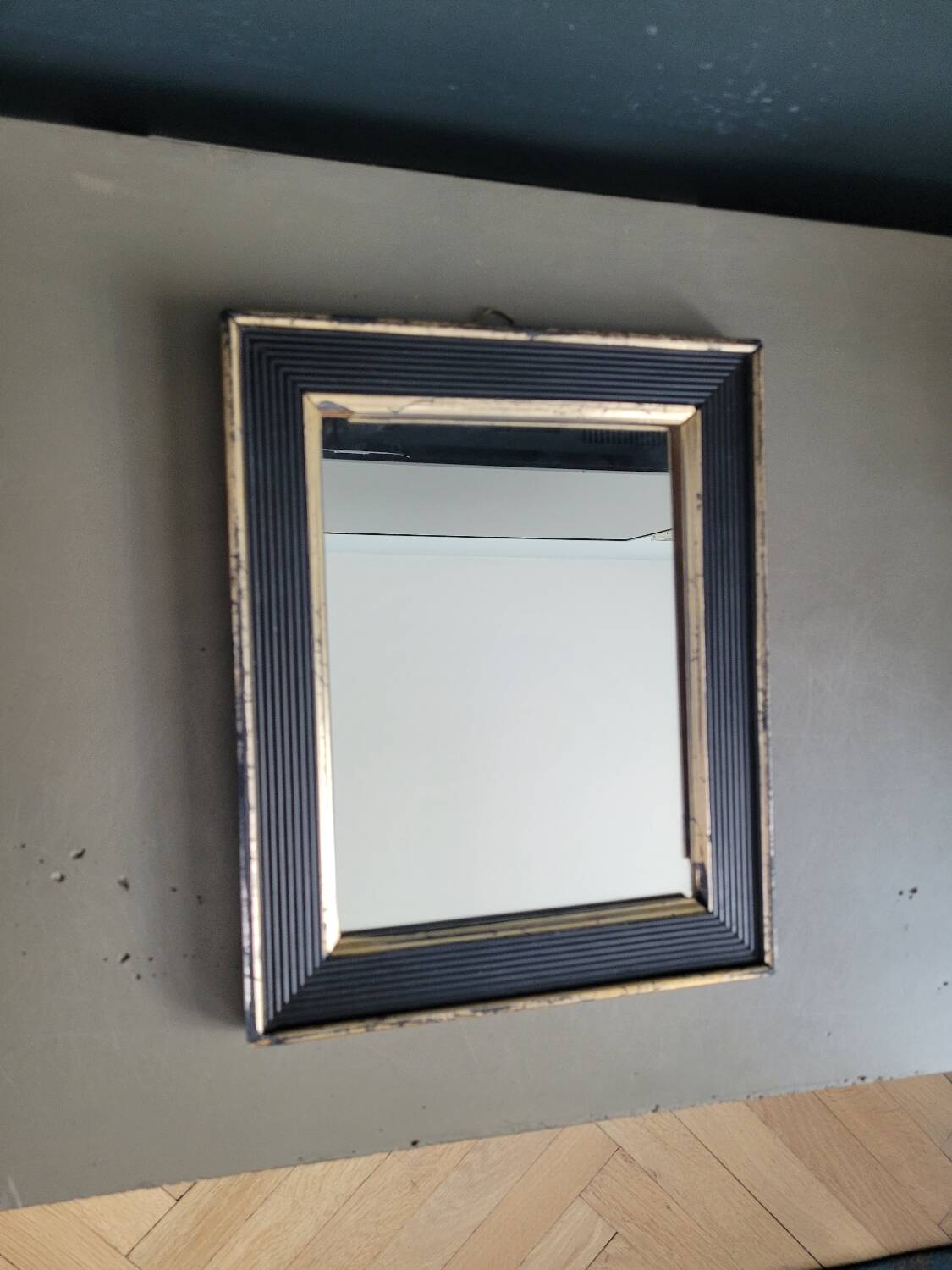 Antique black and gold wooden mirror
