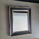 Antique black and gold wooden mirror