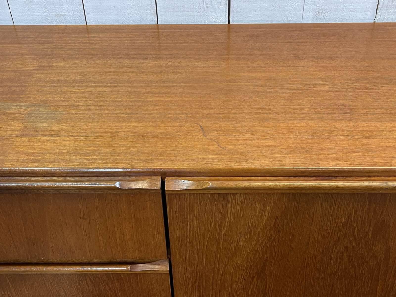 1970s English enfilade in teak with splayed legs.