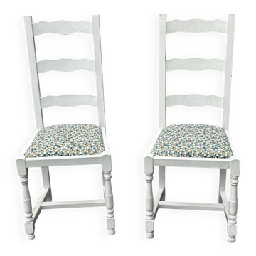 Pair of antique white-painted wooden chairs with high backs.