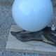 Art Deco lamp in cast iron and marble with a white opaline globe.