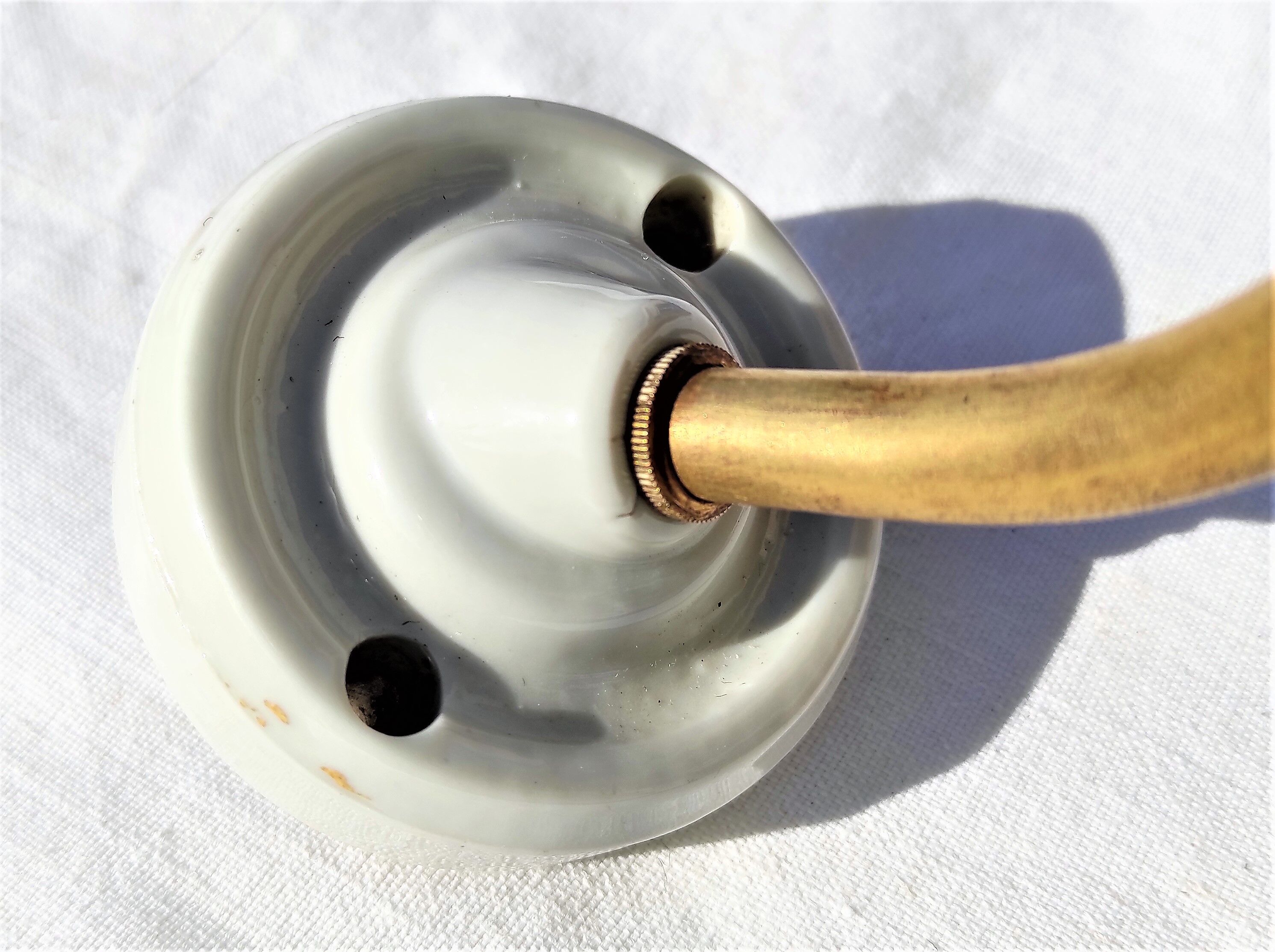 Brass gooseneck wall lamp, with brass socket and porcelain base.