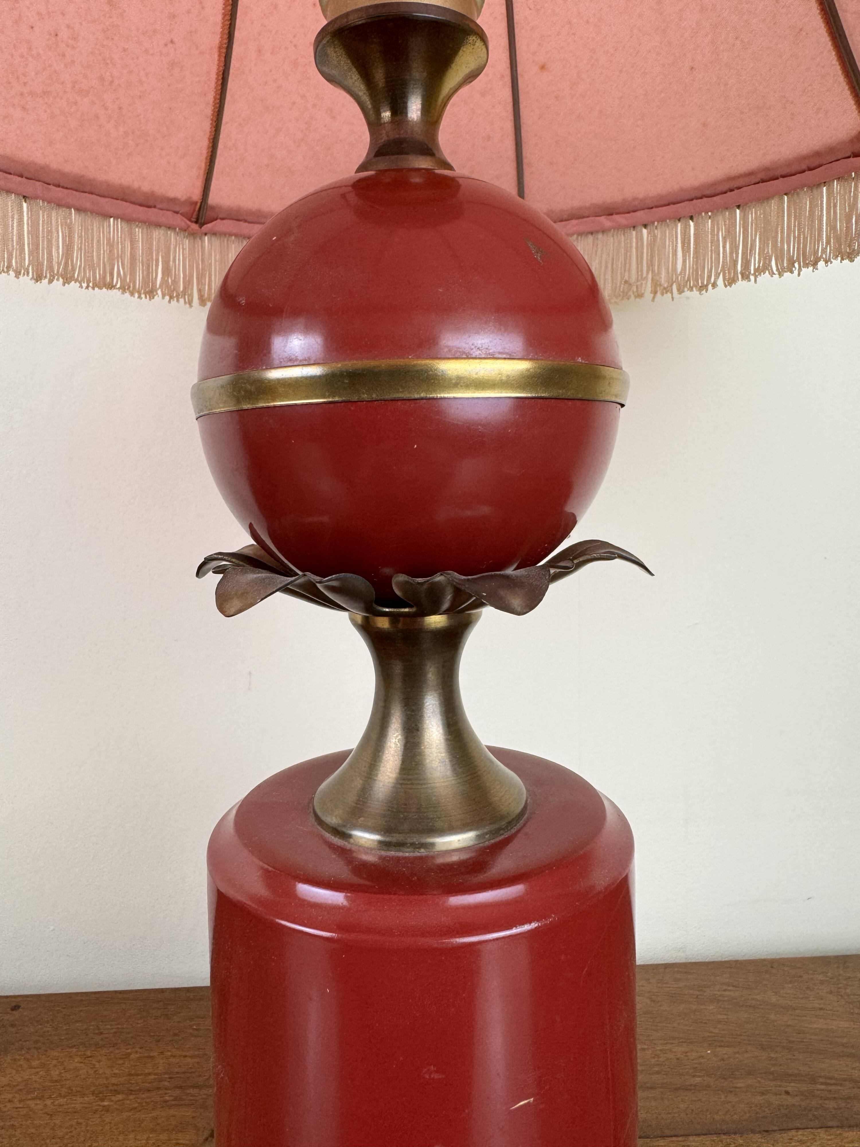 Art deco style desk lamp with a burgundy red sphere in the center the body is in lacquered iron