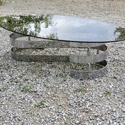 Oval coffee table of the 70s chromed metal base in s smoked glass top