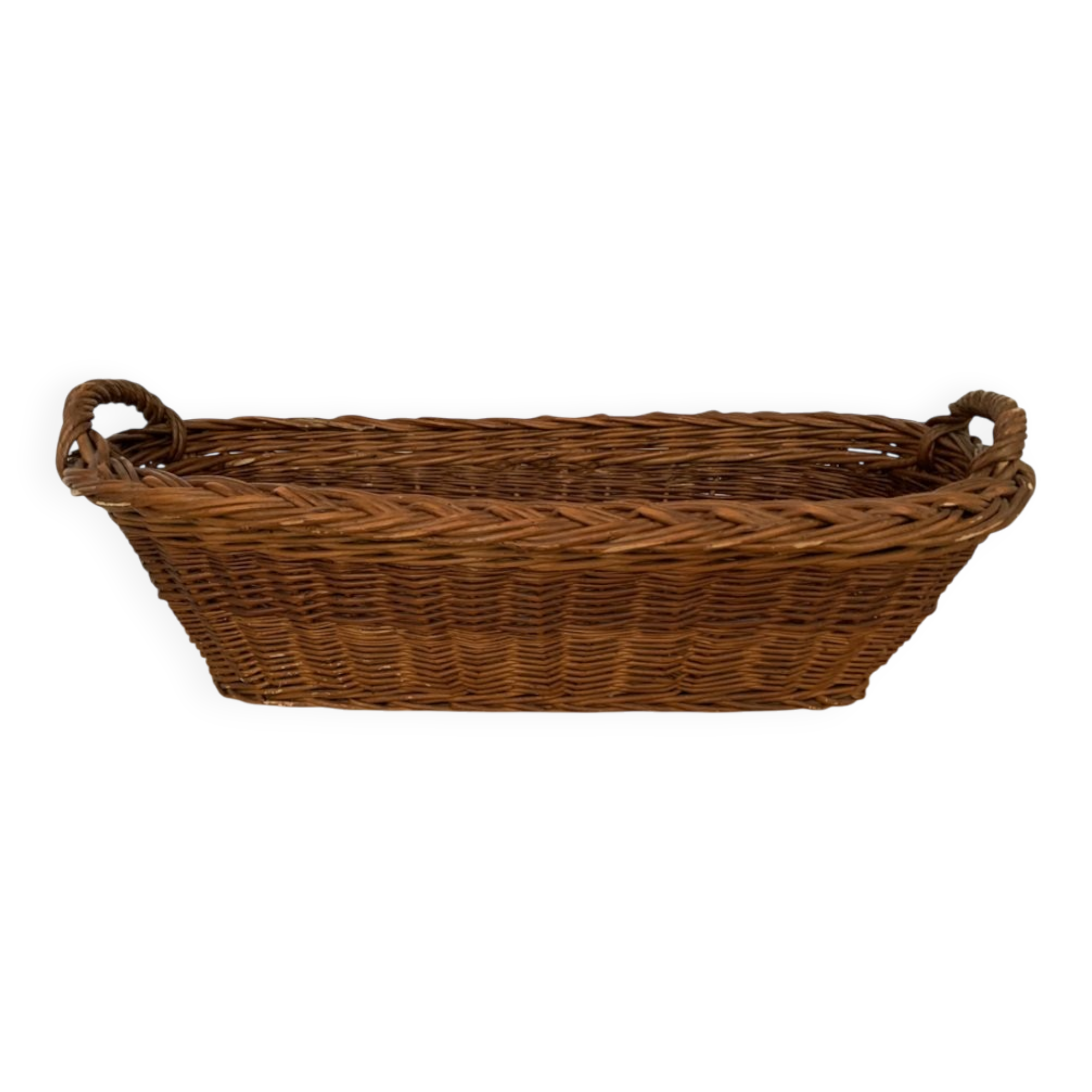 Vintage brown wicker baguette basket, elongated shape, with integrated handles.