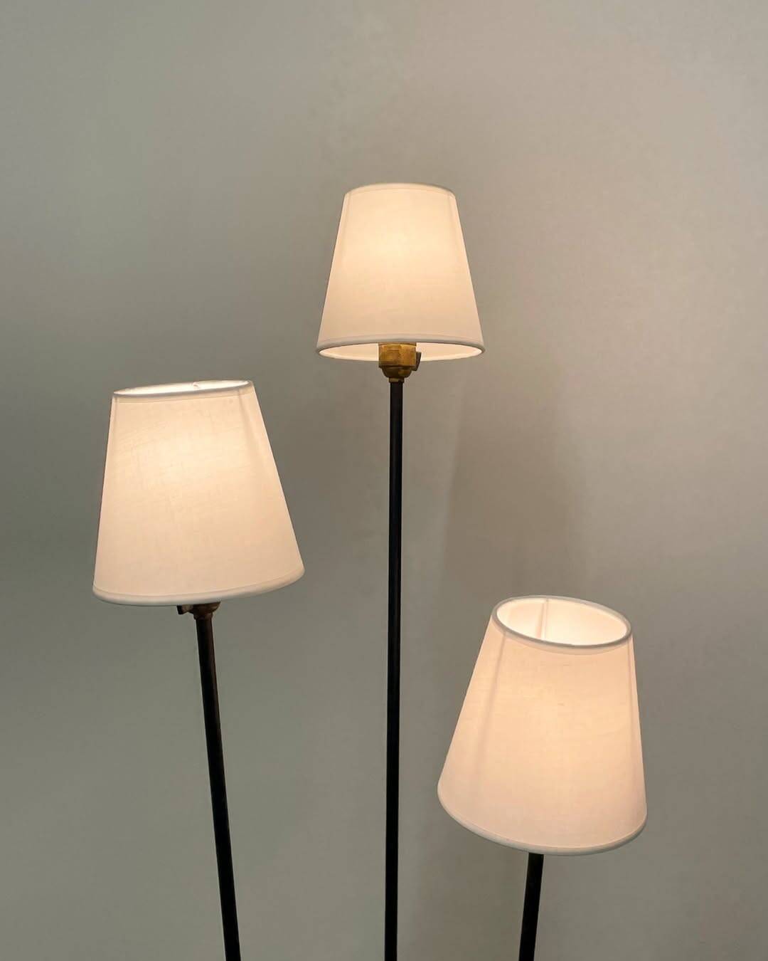 Three-light floor lamp in black lacquered metal, circa 1950.
