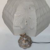 Art Nouveau style lamp, in bronze and frosted glass.