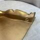 Small corner console in resin with a gold finish.