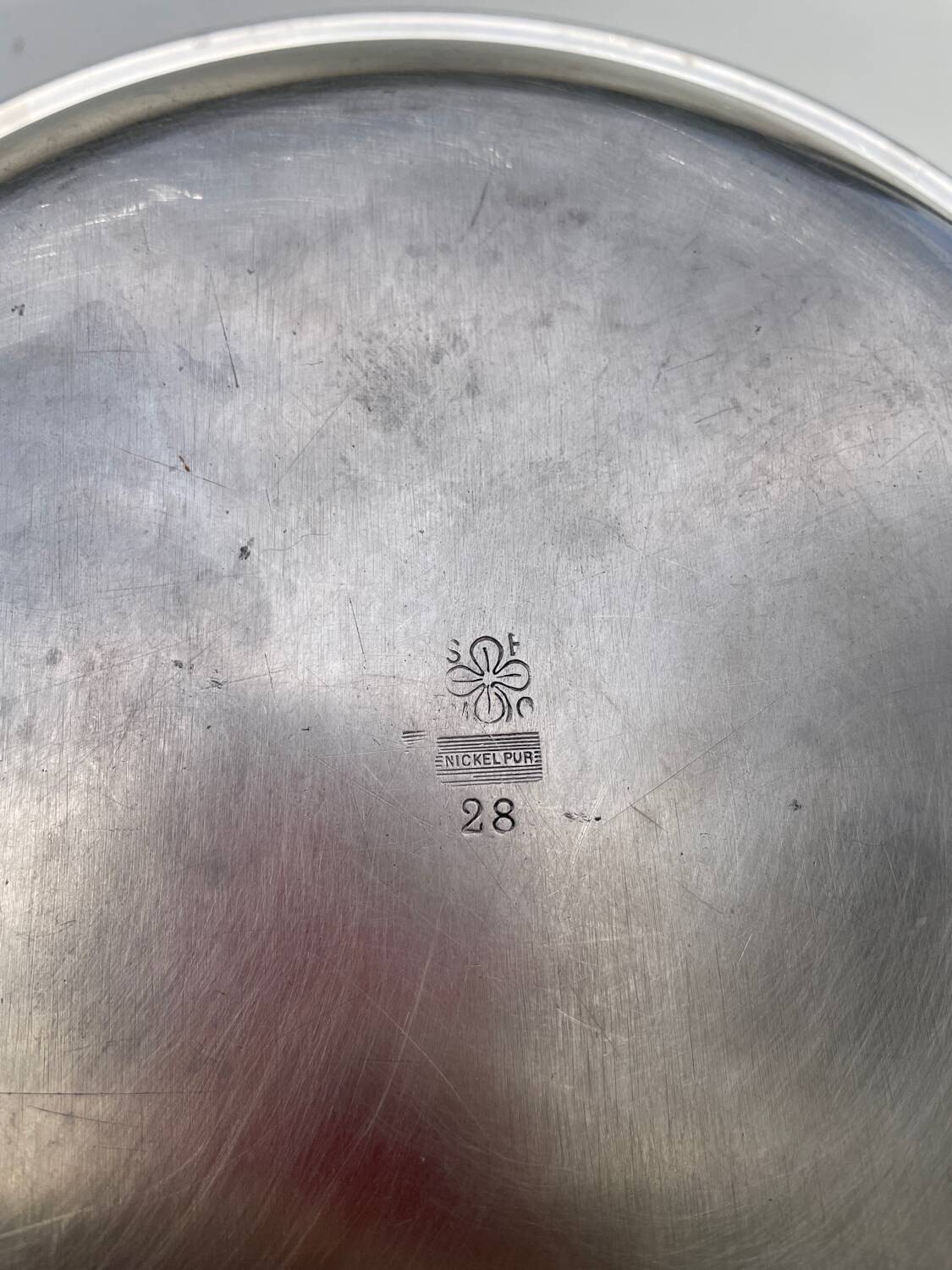 Round silver-plated metal serving dish with hallmark