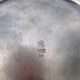 Round silver-plated metal serving dish with hallmark