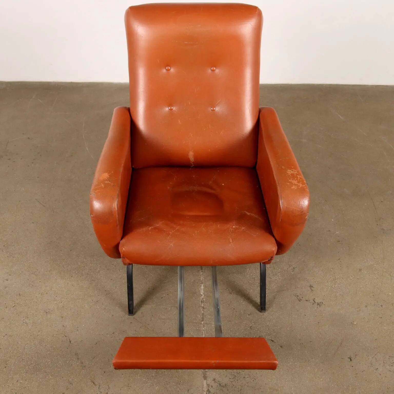 Vintage armchair from the 1970s in foam, faux leather, and metal.
