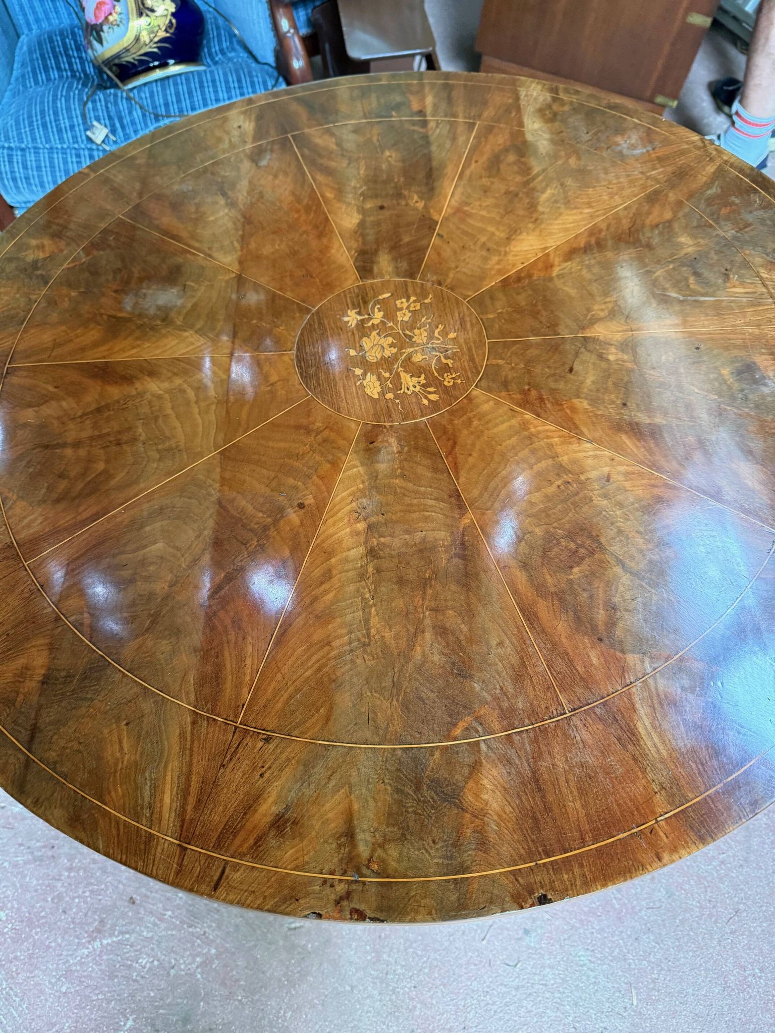 Antique round table with floral details.