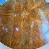 Antique round table with floral details.