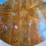 Antique round table with floral details.