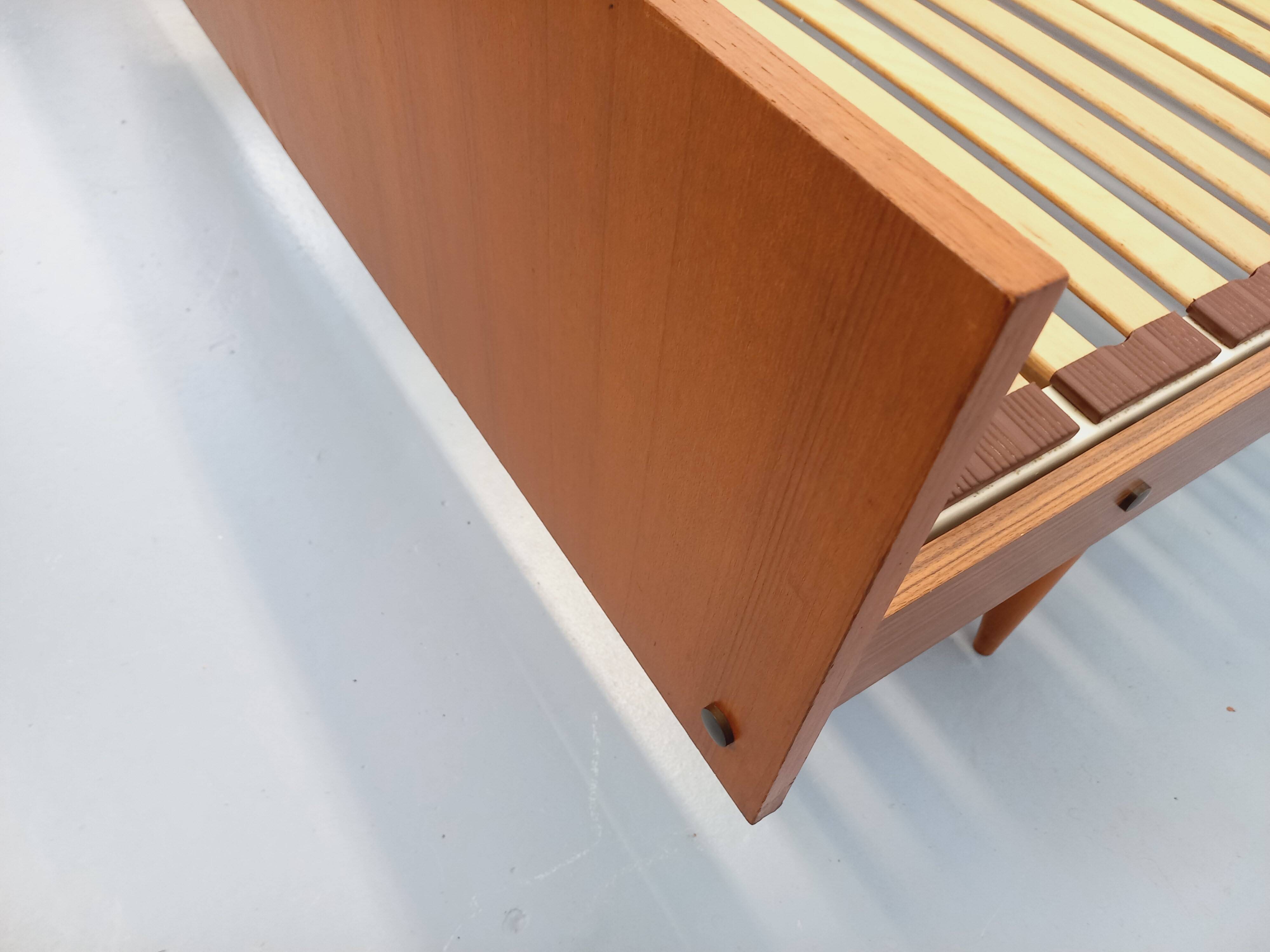Double bed in vintage Scandinavian style from the 1960s with bedside tables in teak.