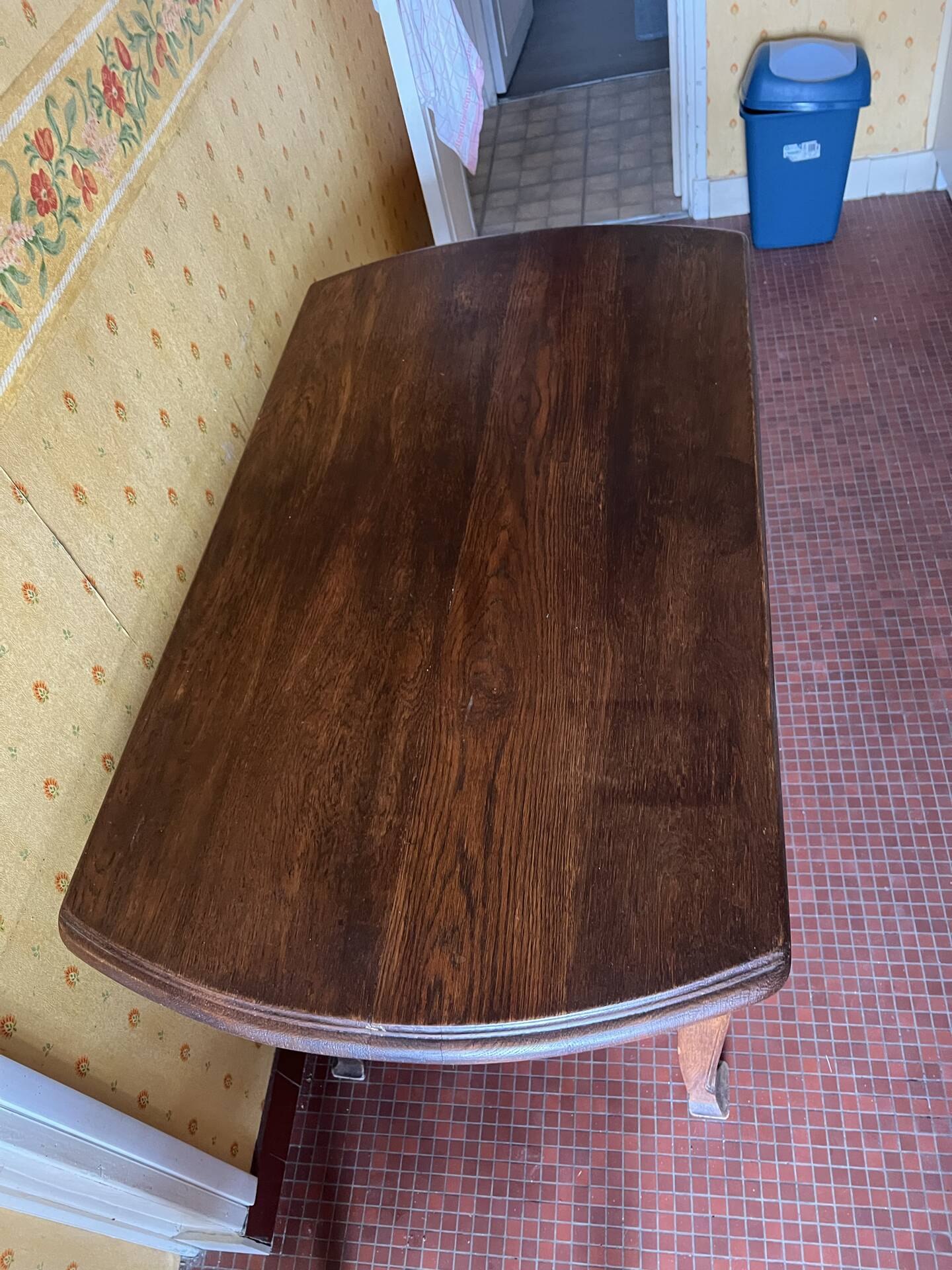 Vintage antique oak table with ornate legs.