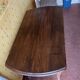Vintage antique oak table with ornate legs.