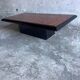 Vintage coffee table in wood burl on a black lacquered base.