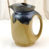 Vintage art deco water pitcher with drippy dark blue glaze.