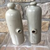 Lot of two old bottles of beige enamelled sandstone bottles