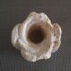 Candlestick in carved stone, signed