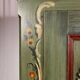 Alsatian bonnet maker in painted softwood with floral decorations