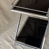 Modernist serving trolley in chromed metal and black smoked glass