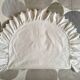 Two half-moon ruffled cushion covers