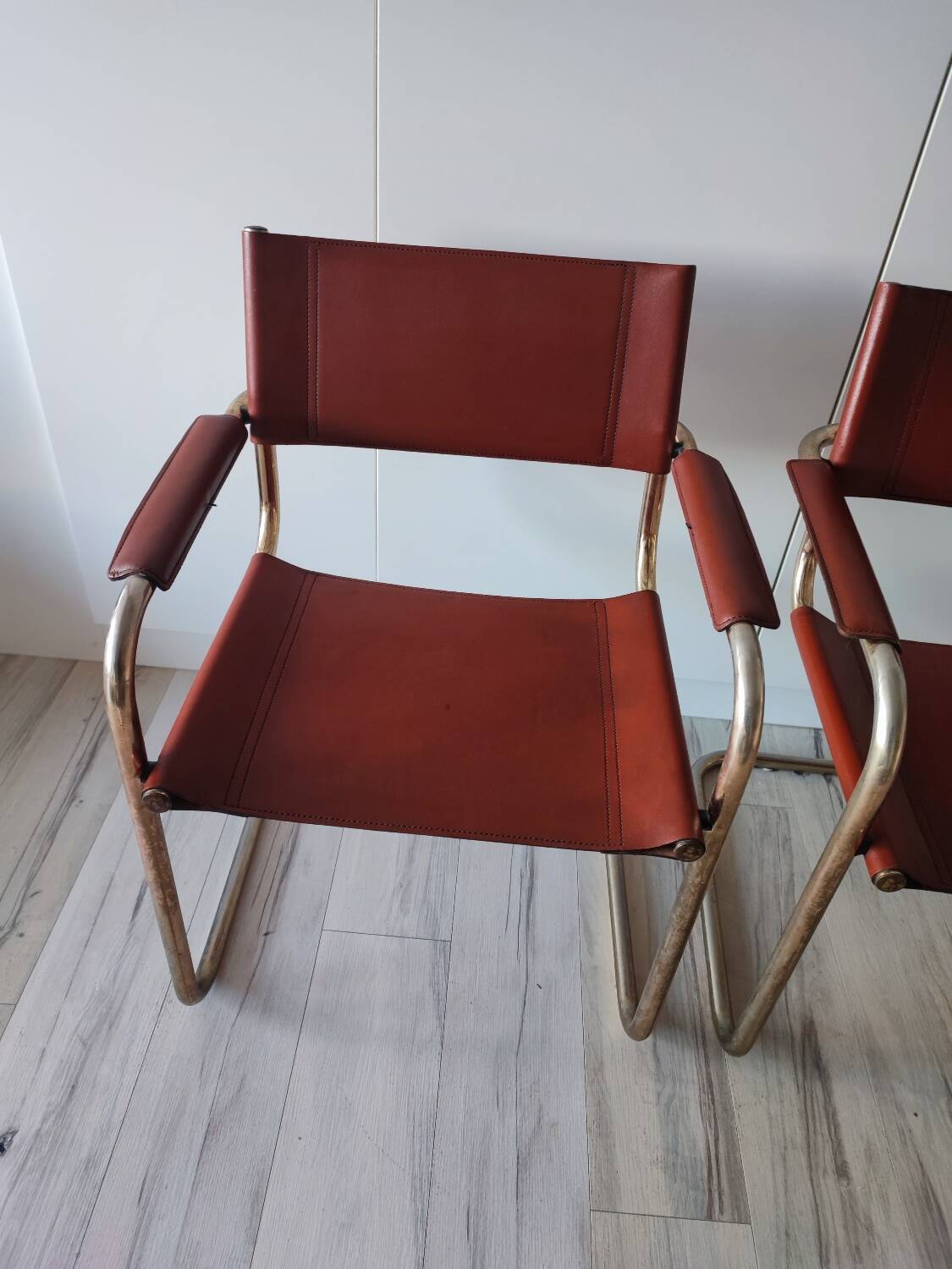 B34 armchairs, cognac leather and gilding