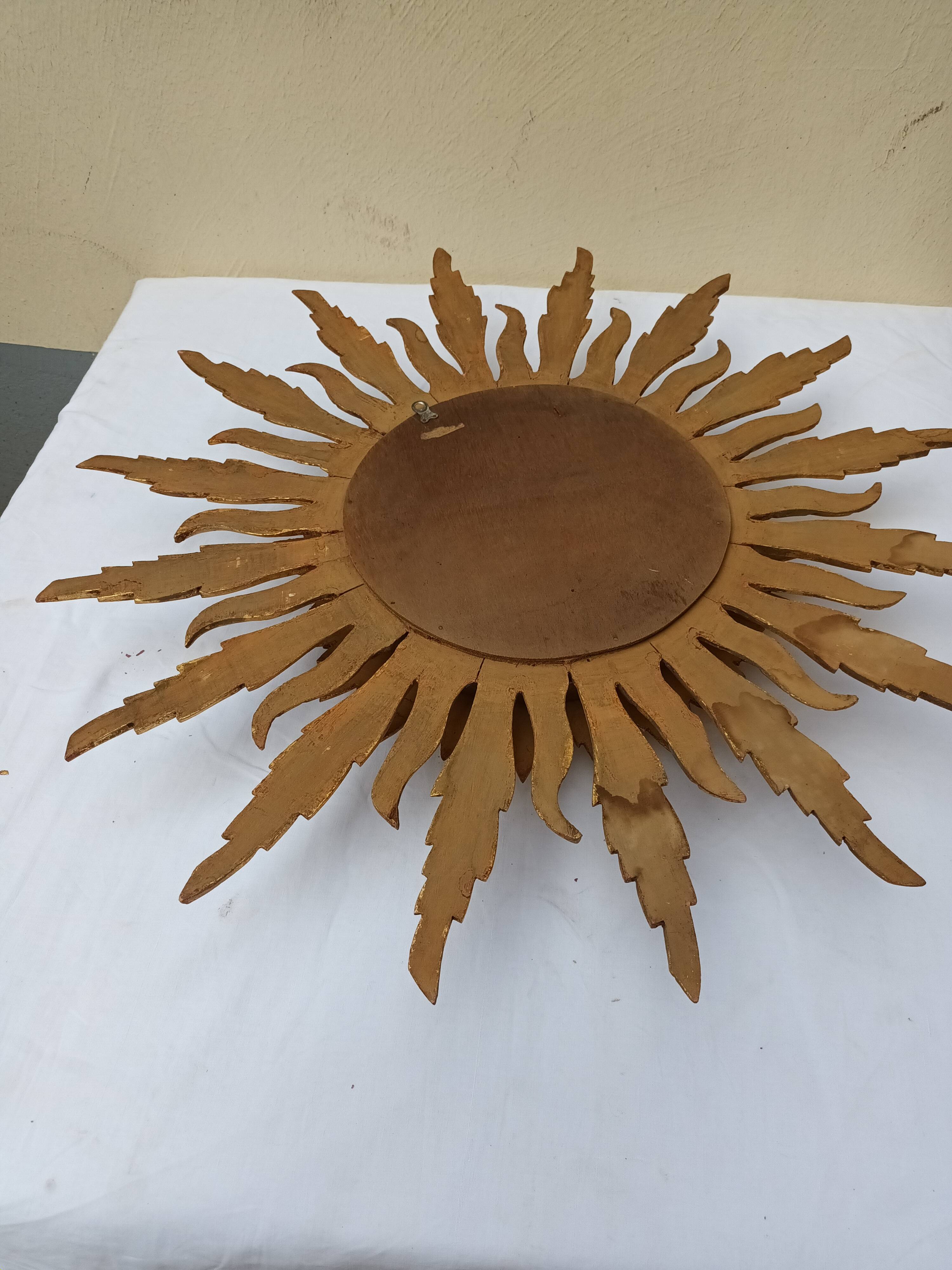 Sun mirror in carved gilded wood from the 1950s