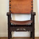 Frailero armchair, antique Spanish — carved wood & full-grain leather.