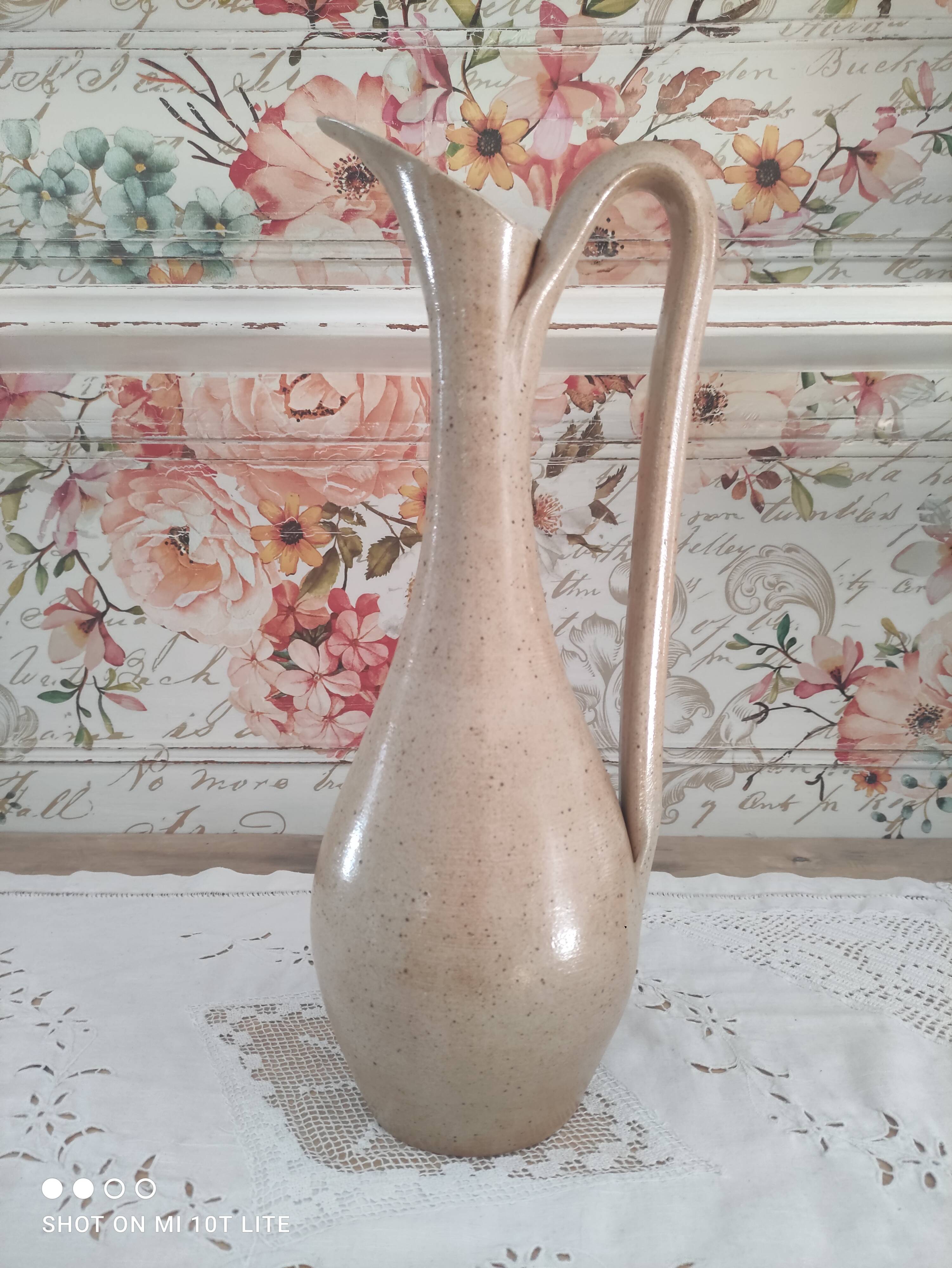Vintage pitcher in light brown sandstone speckled