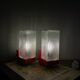 Pair of vintage wall lights in red plastic and clear glass.