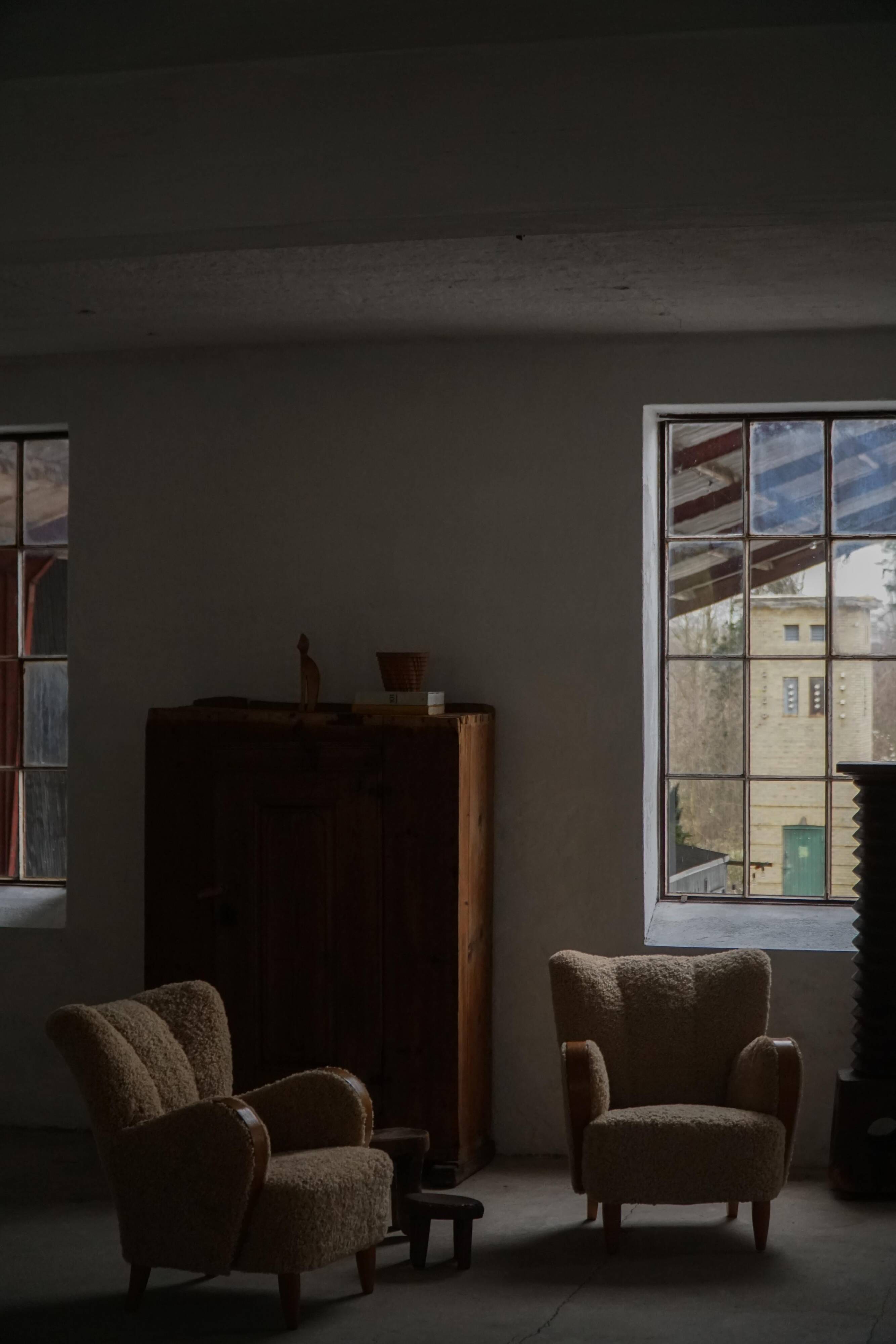 Pair of Danish Art Deco modern lounge chairs in sheepskin with lambswool and elm, 1940s.