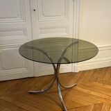 Table ronde en verre fumé et piètement central en inox