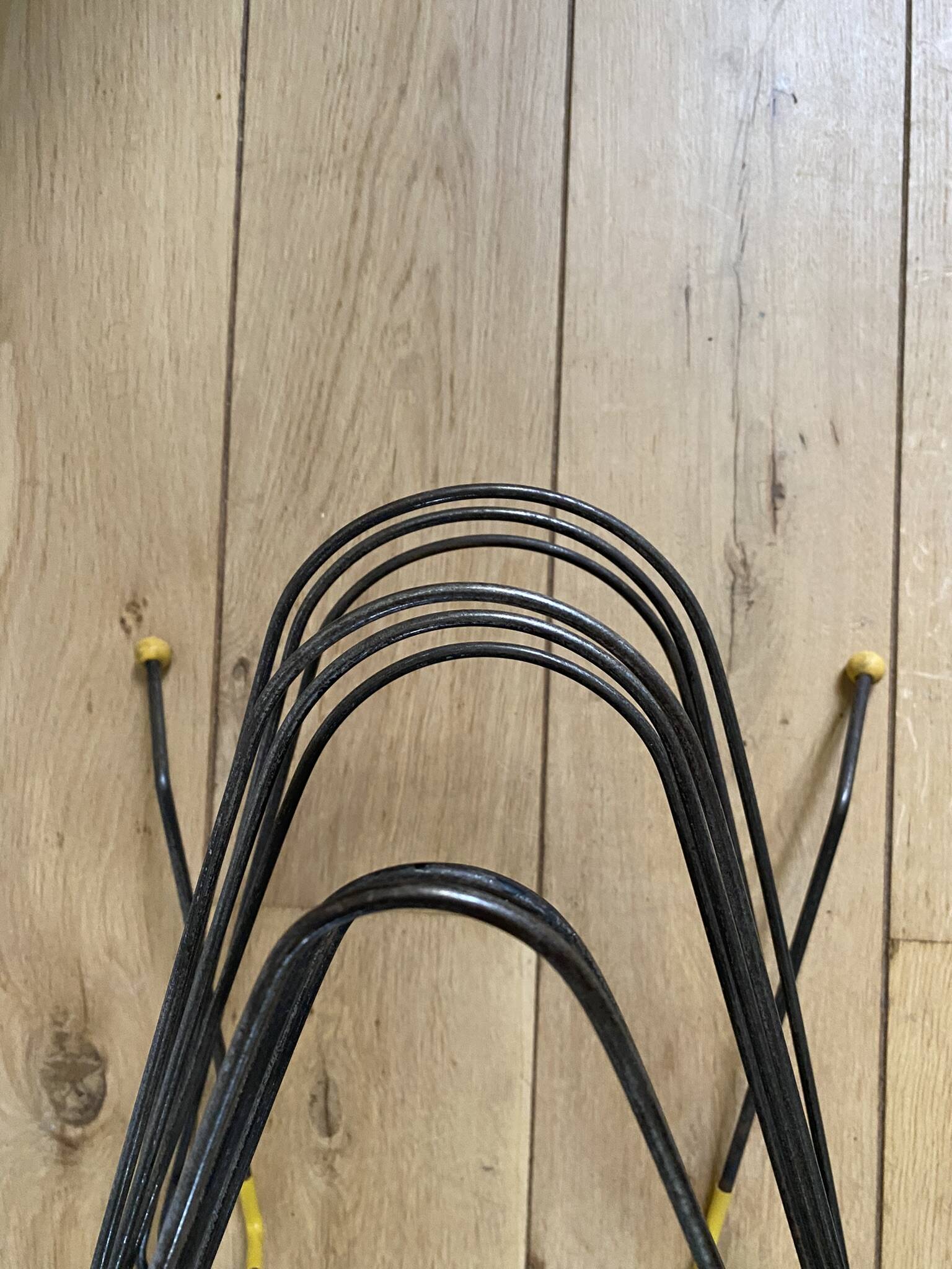 Black metal vinyl record holder and yellow scoubidou from the 60s