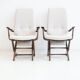 Pair of varnished wooden reclining armchairs, upholstered in lightweight fabric.