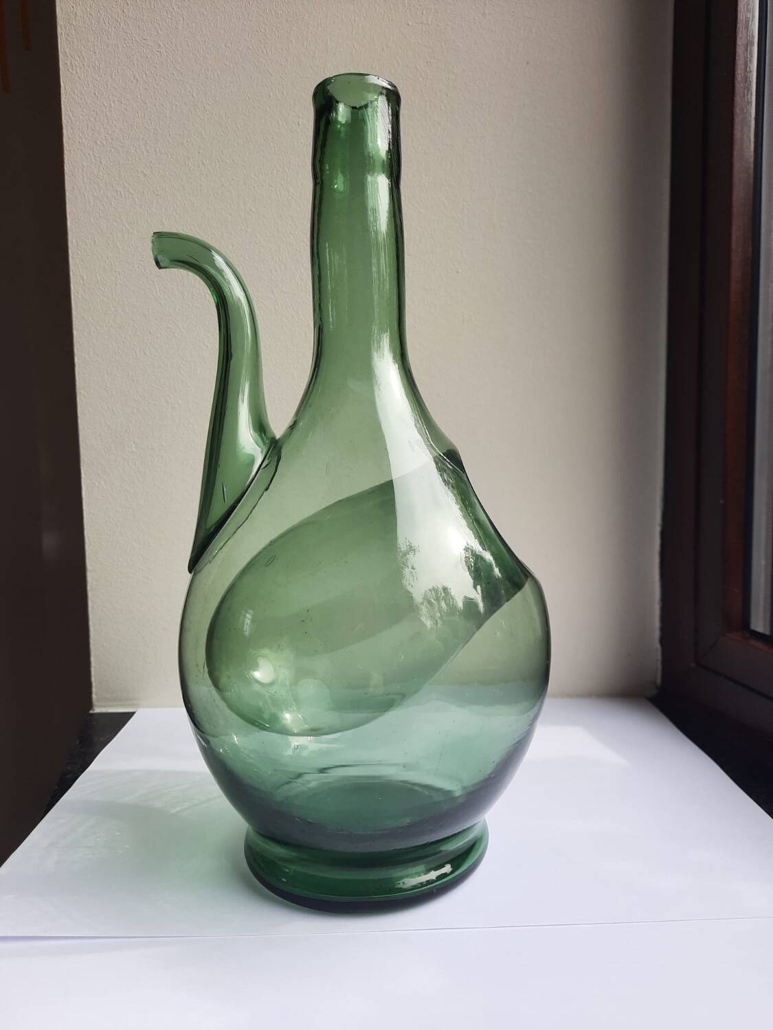 Pair of blown glass wine decanters in blue/green hues.