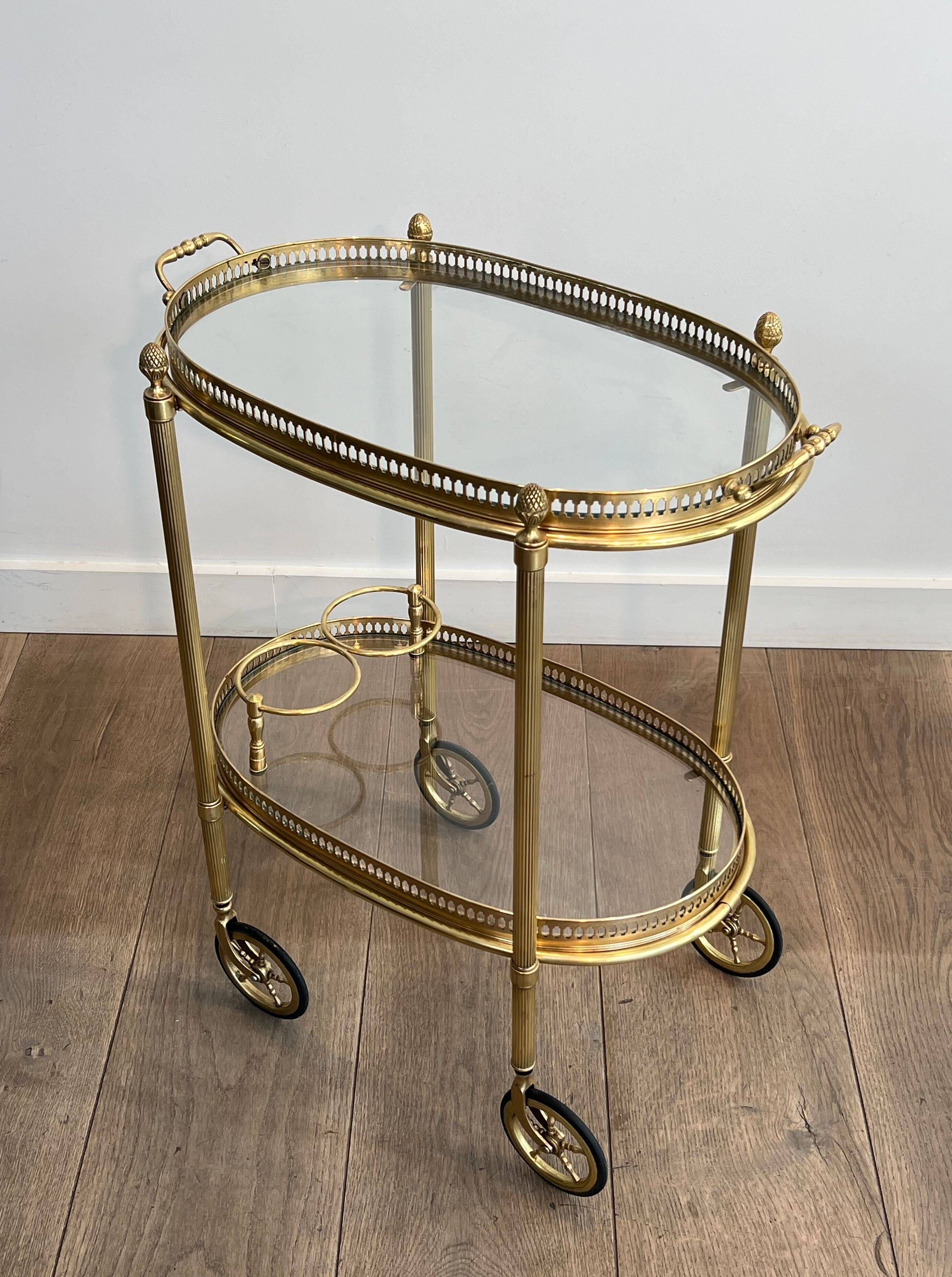 Small oval rolling table in brass with double removable trays from Maison Bagués.