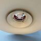 Large UFO flying saucer pendant light with orange light.