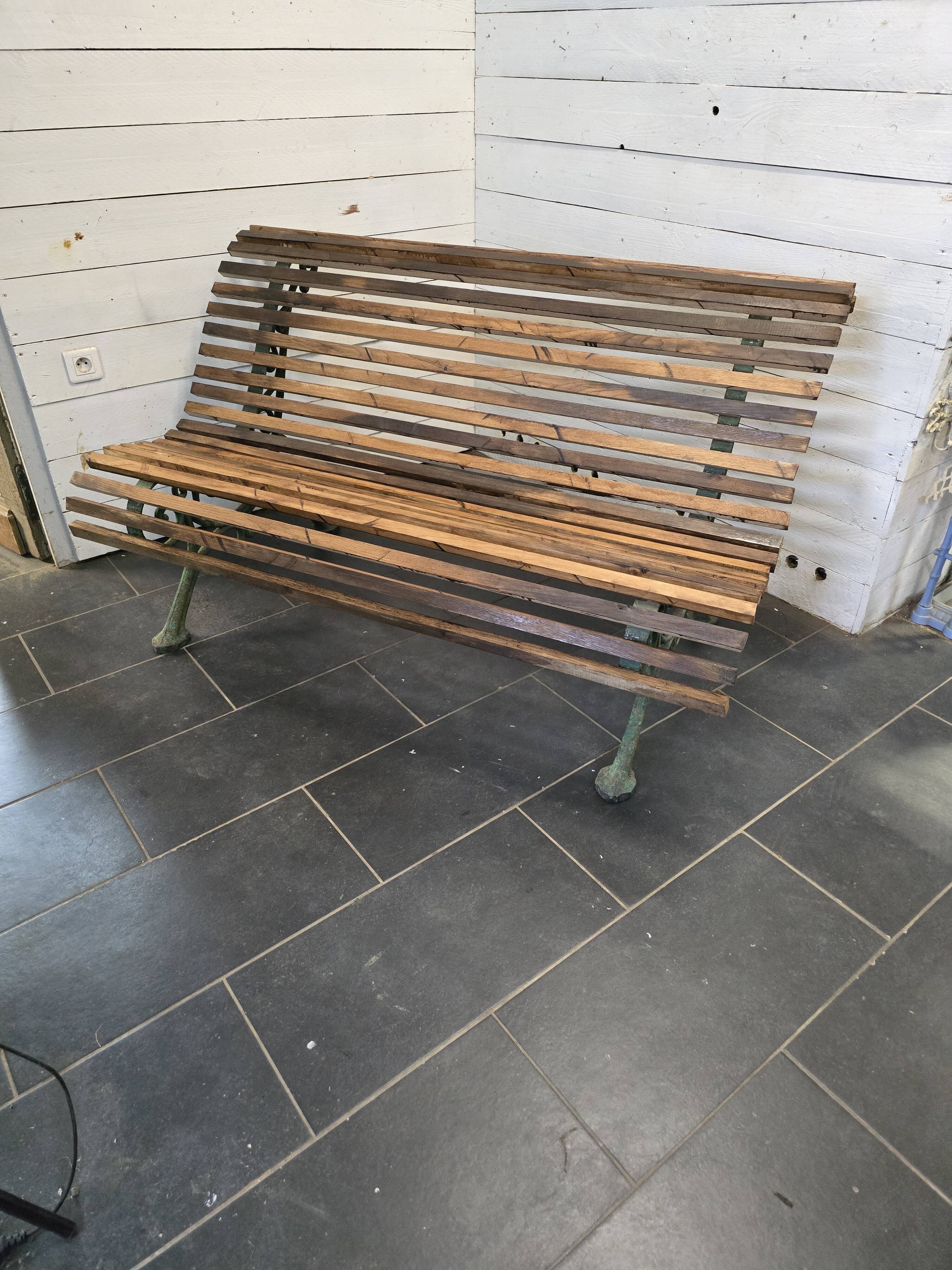 Old cast iron garden bench with oak slats